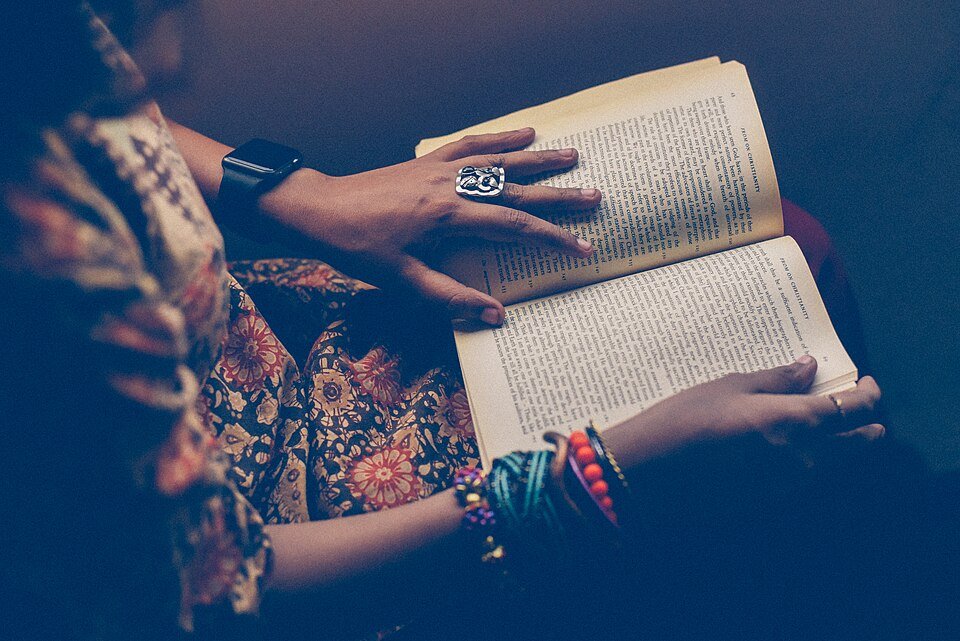 A person reading a book on their lap