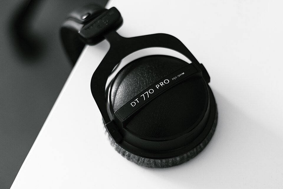 Headphones hanging beside a desk